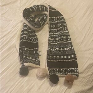 Cozy Black and White Patterned Scarf with Pom Poms